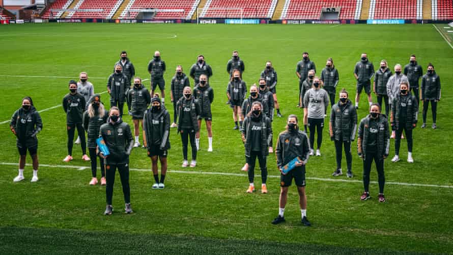 The Barclays manager and player of the Month, Casey Stoney and Tobin Heath, at the front of the rest of the Manchester United squad