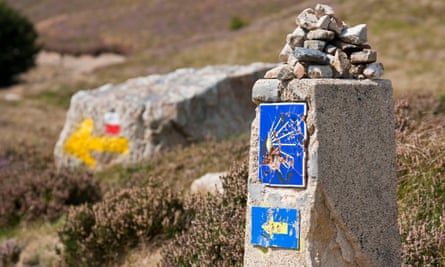 A small pile of rocks has been place on top of a stone signpost along the Camino de Santiago between St Jean Pied de Port and Roncesvalles, France