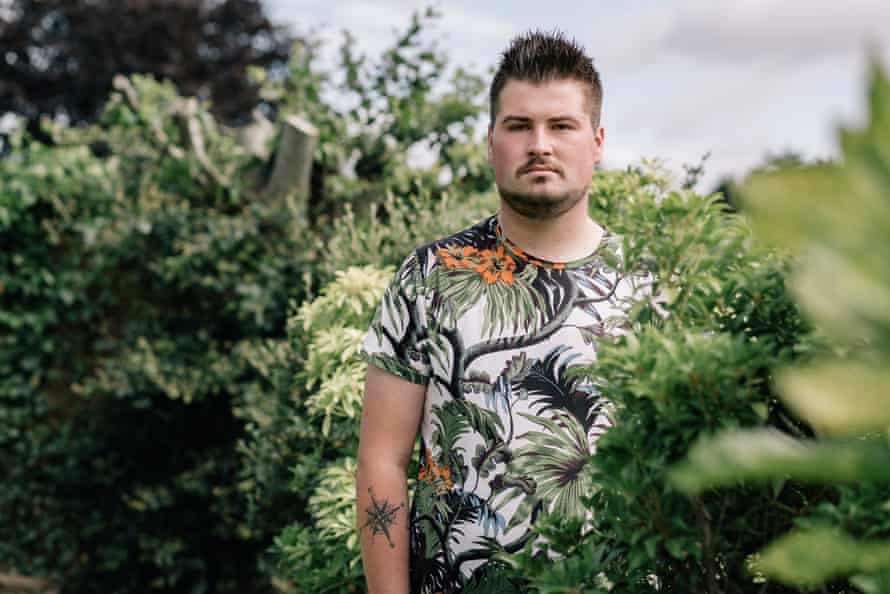 Man standing with bushes around him