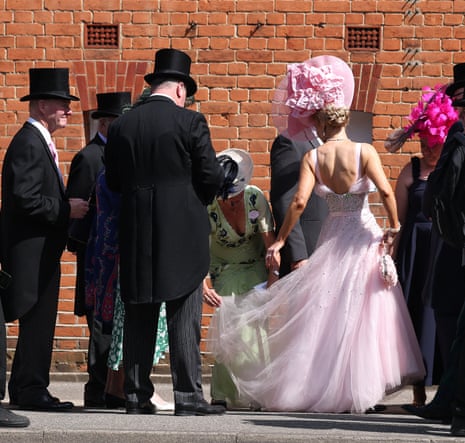 A racegoer's dress is adjusted as they queue to enter Royal Ascot.
