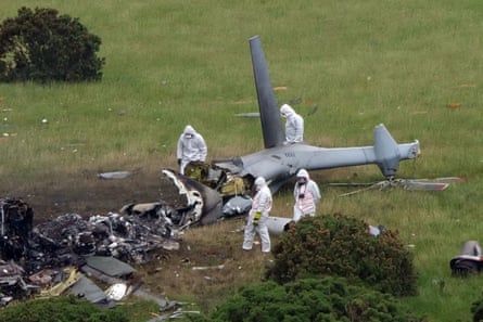 Forensic workers look at the scene of the helicopter crash.