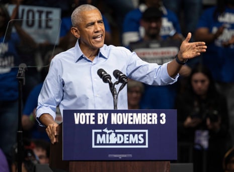 Obama standing at a podium gesturing to a campaign crowd.