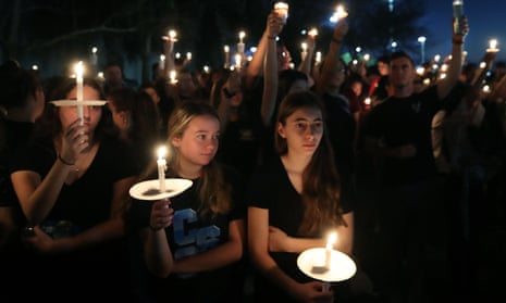 Students and family members attend a vigil for victims of the mass shooting at Marjory Stoneman Douglas high school in Parkland, Florida, on 15 February 2018. 