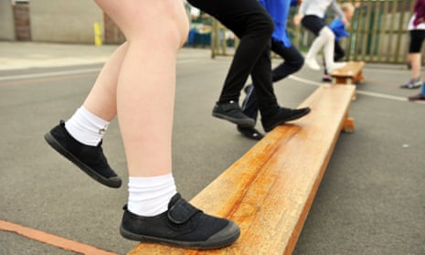 Close up of child's feet wearing plimsolls in a PE class