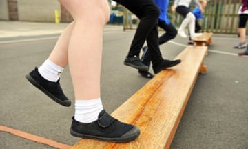 Closeup of children's feet wearing plimsolls in a PE class