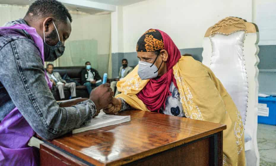 A member of the national electoral board marks a voter’s finger at a polling station in Addis Ababa, Ethiopia