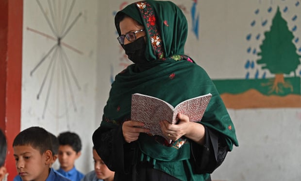 A veiled teacher in a classroom