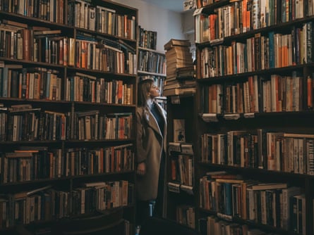 A woman among shelves laden with hundreds of books.