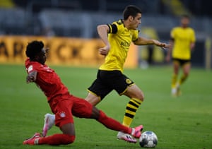 Giovanni Reyna (right) of Borussia Dortmund is tackled by Alphonso Davies of Bayern Munich.