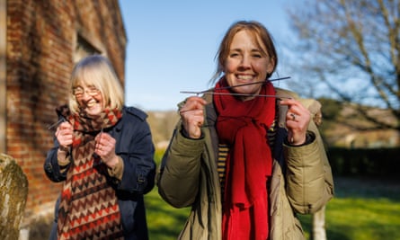 Linda Geddes (right) being introduced to dowsing by her mother Isobel in a Wiltshire churchyard.