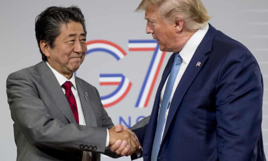 Donald Trump and Shinzo Abe shake hands following a news conference in Biarritz.