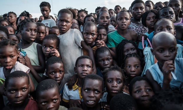 Children wait to receive food at an evacuation centre in Dondo, about 35km north of Beira, Mozambique.