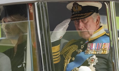 King Charles III salutes as he leaves Westminster Abbey on Monday.