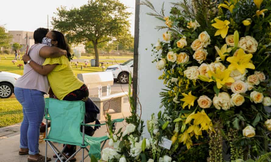 Mourners hug each other at Houston Memorial Gardens cemetery, where George Floyd was buried.