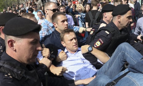 Russian police carry Alexei Navalny from an anti-Putin protest in Moscow, May 2018.