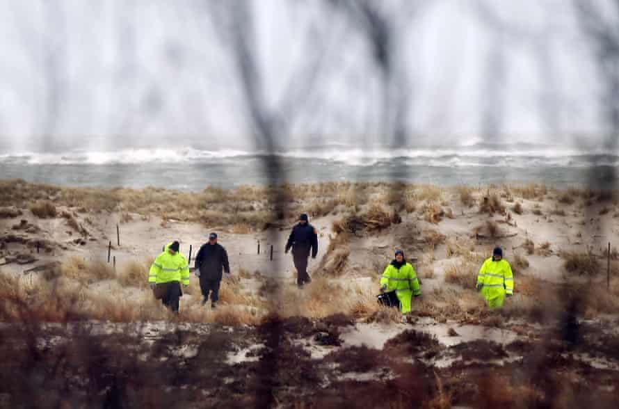 Suffolk county Police and police recruits search an area of beach near where police had recently found human remains in 2011 in Babylon, New York.
