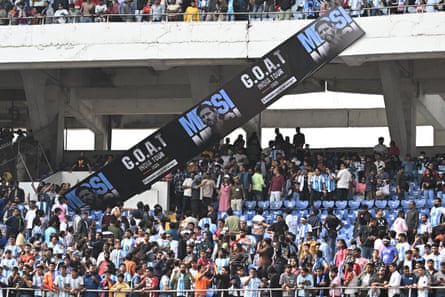 A Lionel Messi banner is knocked down in the stadium