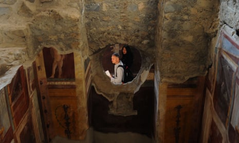 Visitors walk inside the Criptoporticus Domus