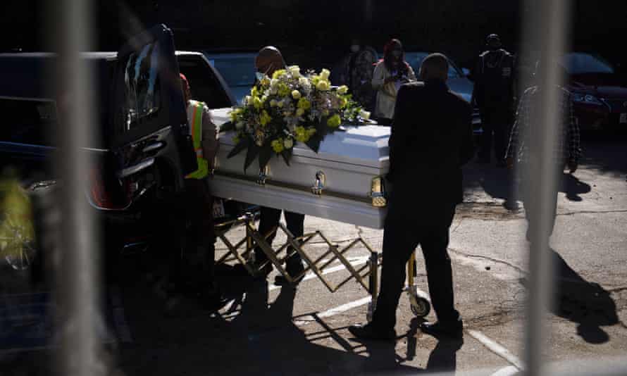 A casket is loaded into a hearse at the Boyd Funeral Home, as burials at cemeteries are delayed due to the surge of Covid-19 deaths, in Los Angeles, California.