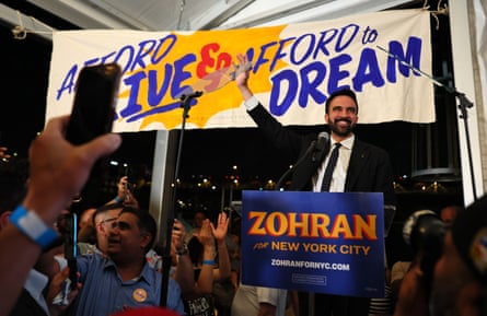 a man waves behind a podium