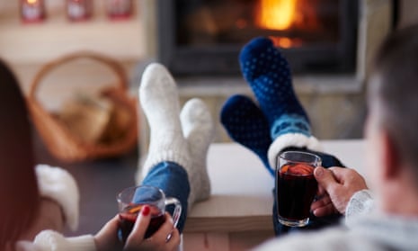 couple put their feet up by the fire