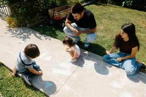 People using chalk to draw on pavement