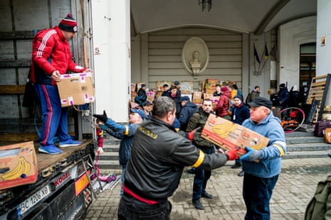 Volunteers unload and distribute boxes of aid in Lviv.