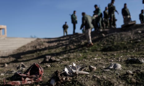 Bones, hair and traditional Yazidi garb are seen at the site of a suspected mass grave 5km east of Sinjar, Iraq, on 15 November 2015. Kurdish Regional Government officials said they strongly suspect to find the remains of 78 elderly Yazidi women that are thought to have been murdered by Isis.