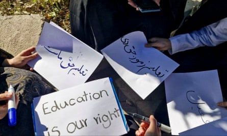 Hands can be seen holding signs in English and Pashto. One reads ‘Education is our right.’