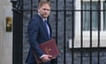 Grant Shapps holding a red state folder and walking outside No 10