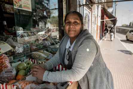 Rosa Valencia in front of the window of her grocery shop