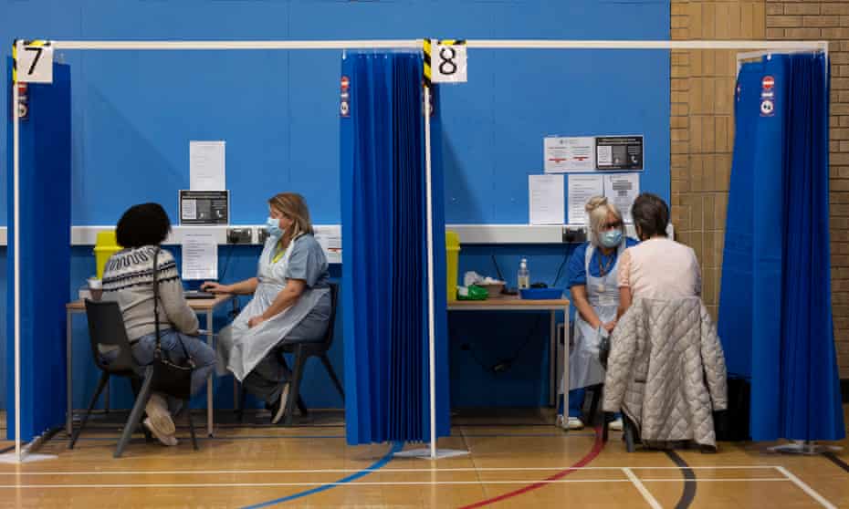 Health workers and patients at a vaccination centre in a leisure centre in Barry, Wales