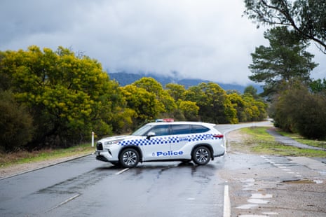 A police car blocks a road
