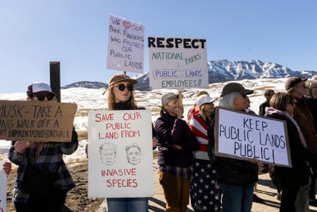 people hold signs in support of public lands