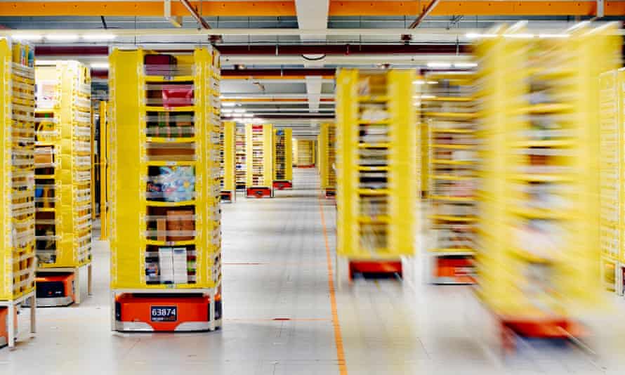 Robots move shelves around inside the ‘cage’ at Amazon