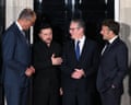 Zelenskyy, Merz, Starmer and Macron stand talking in front of a black door