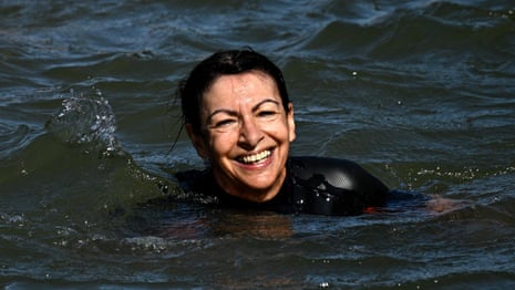 Paris mayor swims in Seine to show river is clean enough for Olympics – video