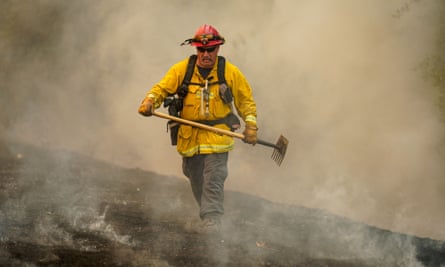 A firefighter walks through a burn area along Solar Hills drive during the Hennessy fire.