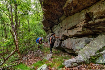 Two people near an archaeological site on a trail