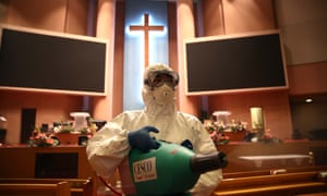 A coronavirus disinfection worker sprays anti-septic solution in a Yoido Full Gospel church in Seoul, one of the biggest churches in South Korea.