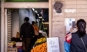 A woman uses a QR code at a food market in Bankstown in Sydney.