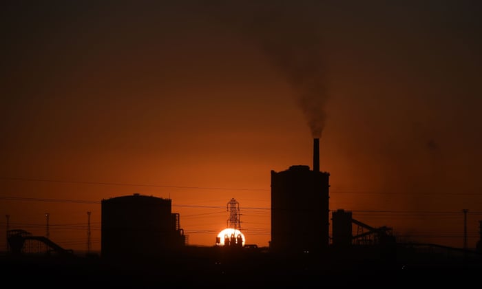 The sun sets beyond the Tata Steel steel plant at Port Talbot, south Wales on March 30, 2016.