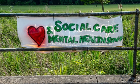 A hand-painted ‘Love Social Care and Mental Health staff’ banner on park railings near Wycombe Hospital. 