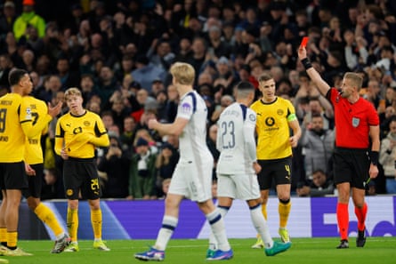 Referee Glenn Nyberg shows a red card to Borussia Dortmund’s Daniel Svensson during the first half