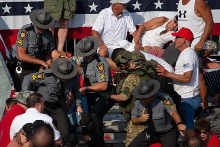 A person is removed by state police from the stands after guns were fired at Republican candidate Donald Trump at a campaign event at in Butler, Pennsylvania, on 13 July 2024.