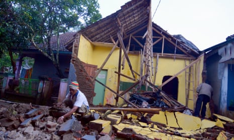 People inspect the ruins of a house in Tasikmalaya in West Java after an earthquake.