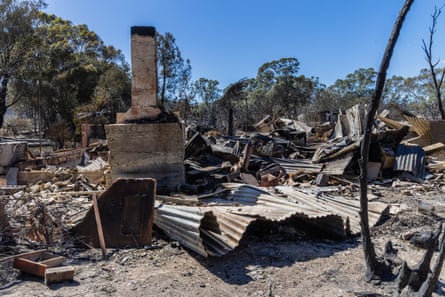 A chimney stands amid rubble