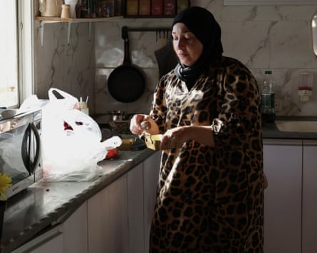 Woman in a kitchen coring an avocado
