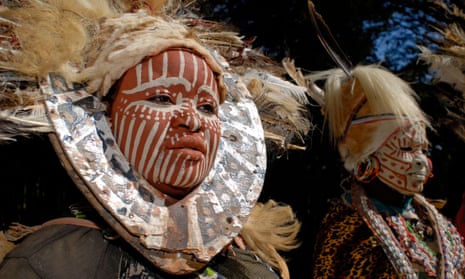 Two women with painted faces and headdresses