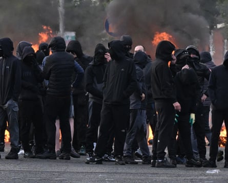 A gang of youths in Belfast, dressed in black with covered faces